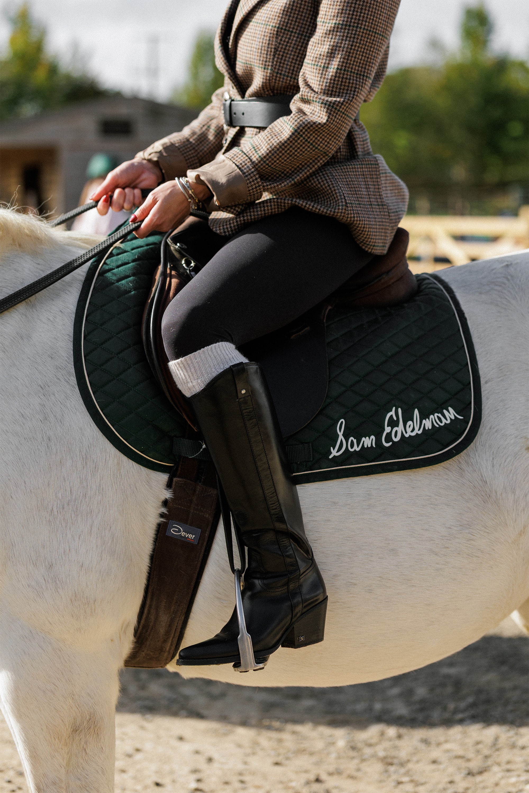 woman on a horse wearing the wyatt knee high boot in black