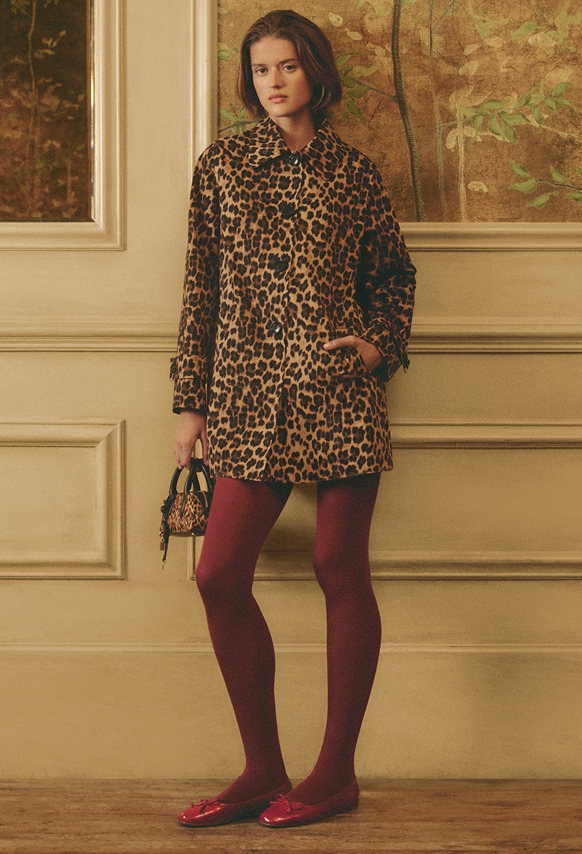 woman wearing a leopard dress with red tights and shoes