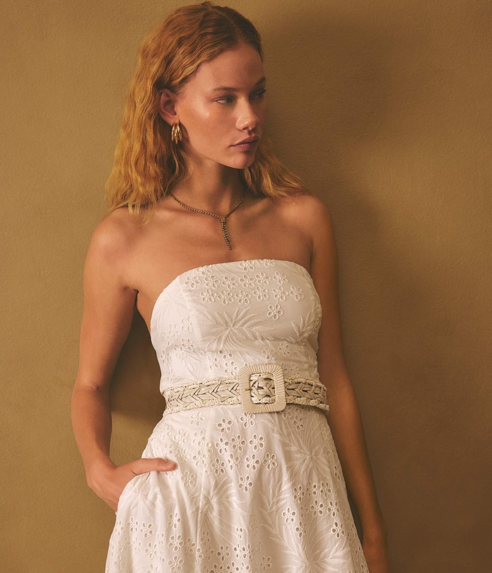 a woman wearing a Strapless Belted Eyelet Midi Dress