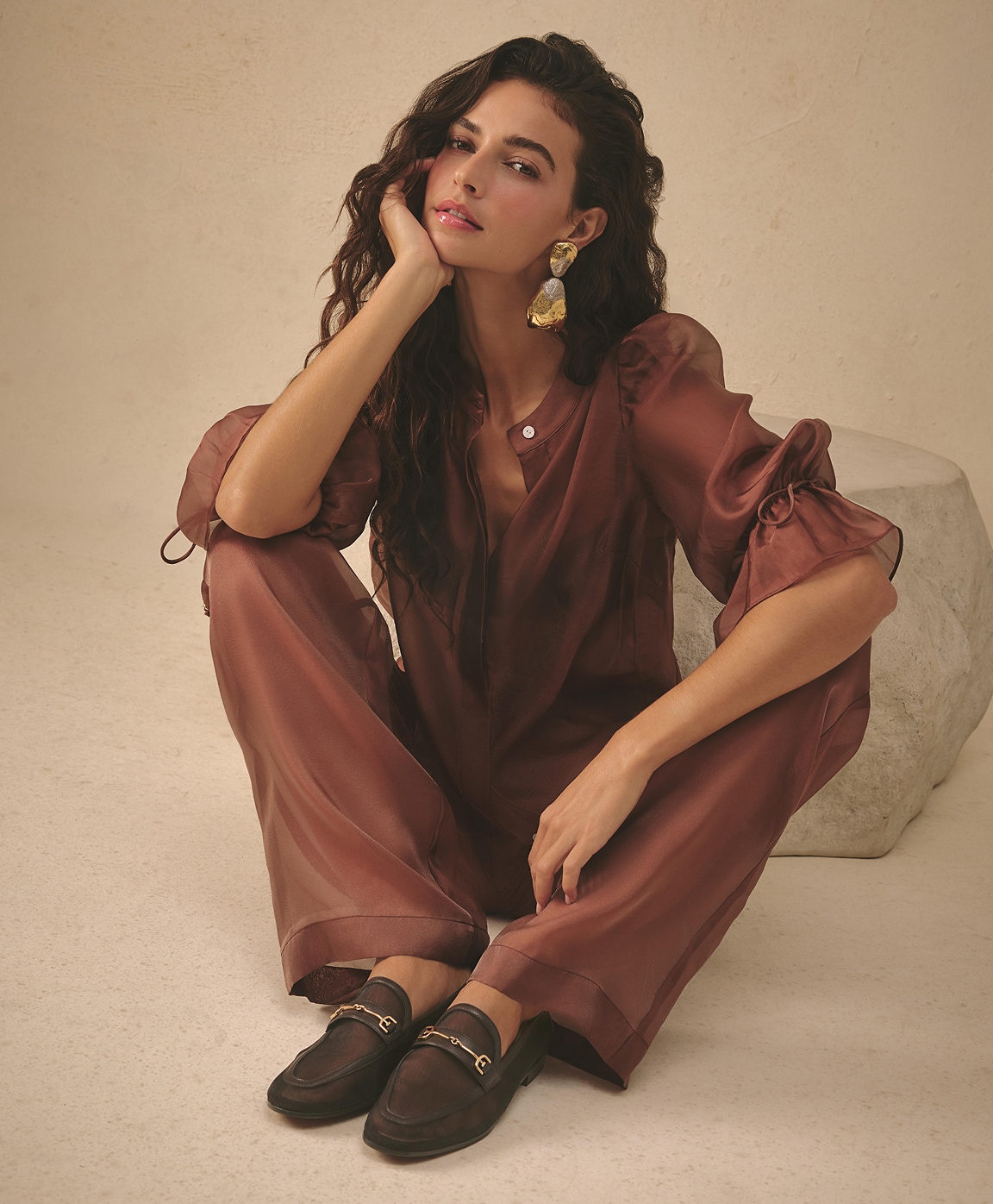 woman wearing a toffee colored, lightweight, sheer blouse and matching bottoms with the loraine mesh loafer in cafe noir