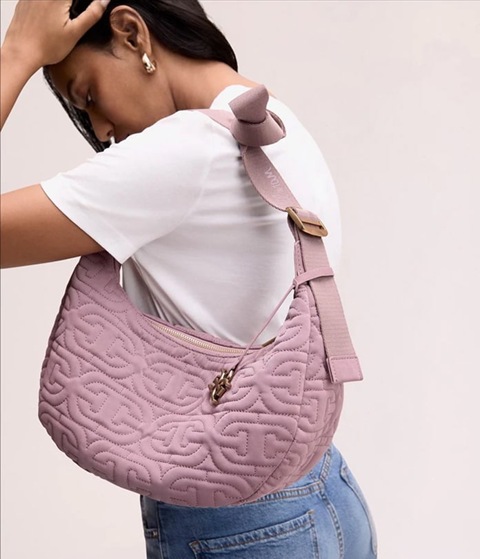 handbags featuring the Ethyl Quilted Logo Sling Crossbody in lilac
