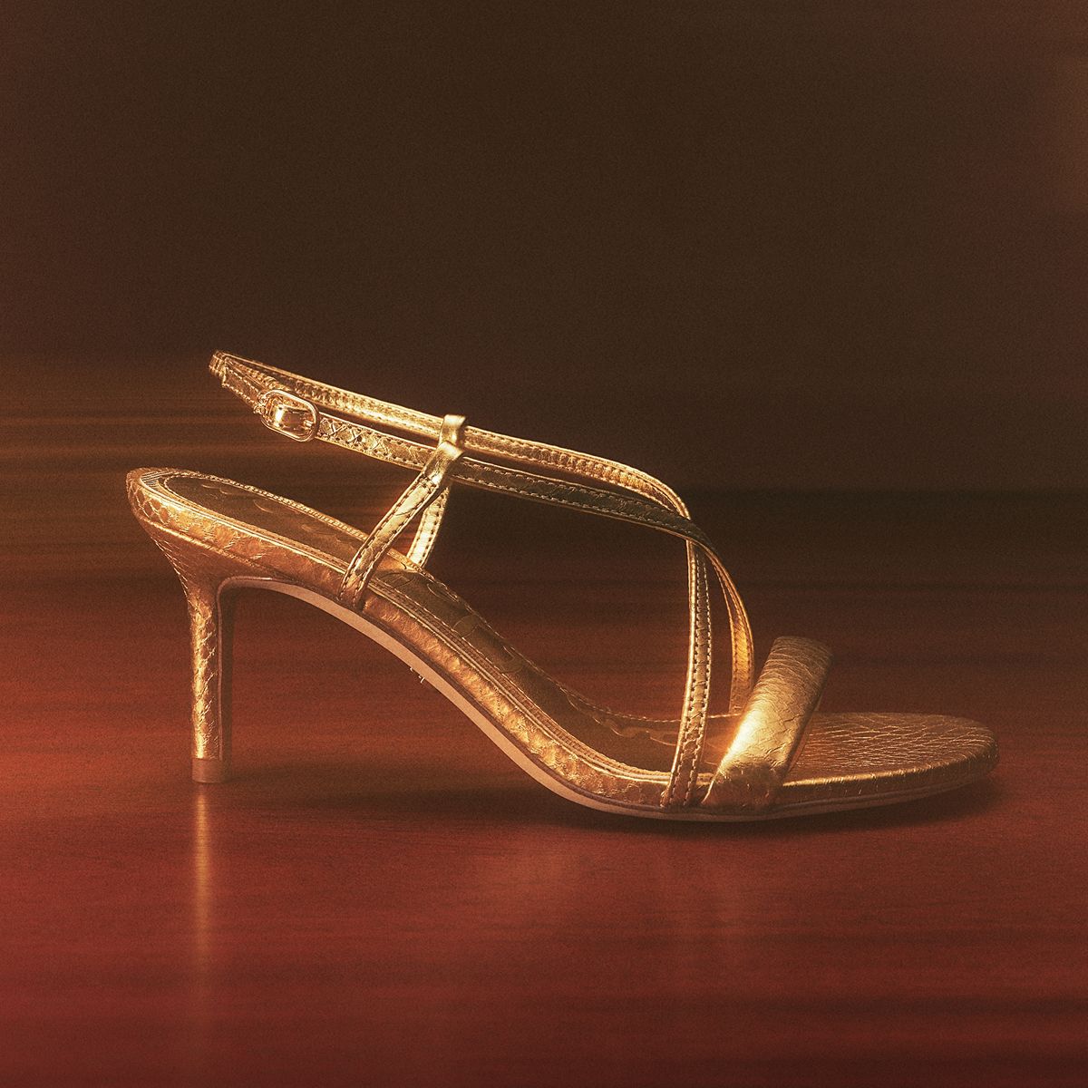Sam Edelman Ginny Strappy Heel Sandal in amber gold leather featuring an adjustable buckle ankle strap.